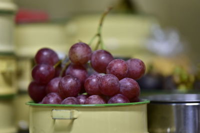 Close-up of grapes in container on table