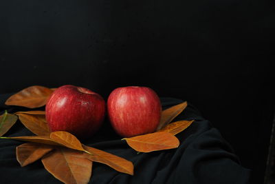 Close-up of apples and fruits against black background