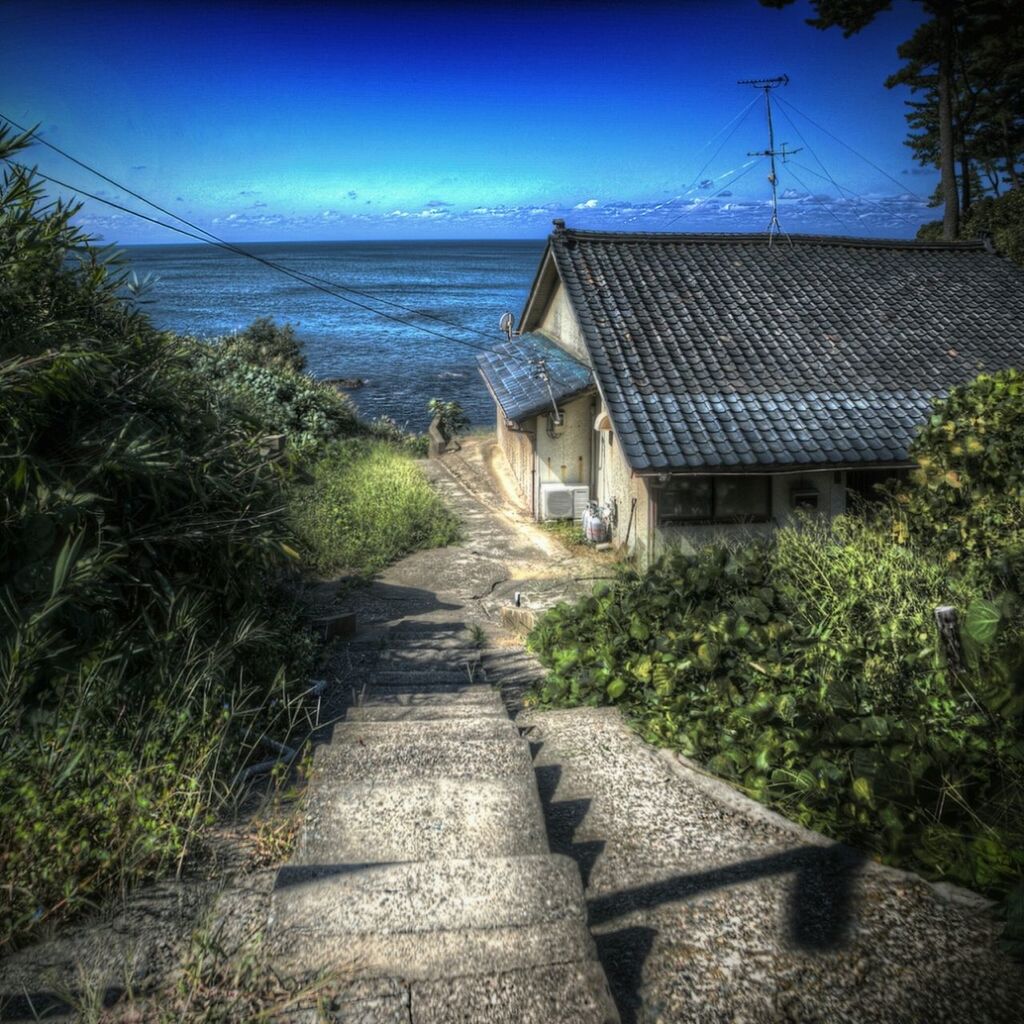 built structure, the way forward, architecture, building exterior, blue, house, sky, tree, clear sky, walkway, narrow, water, pathway, sunlight, leading, sea, long, outdoors, day, town