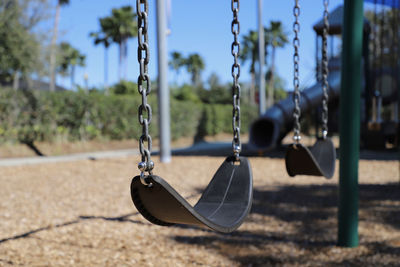 Empty swing in deserted childrens playground