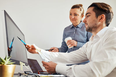 Business people discussing data on computer screen in office. coworkers working together. teamwork