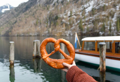 Woman holding a pretzel.