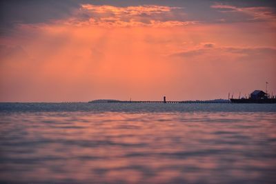 Scenic view of sea against orange sky