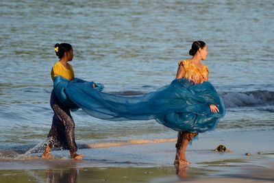 Full length of woman standing in water