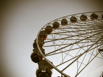 Low angle view of ferris wheel against sky