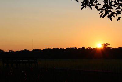 Silhouette landscape against clear sky during sunset