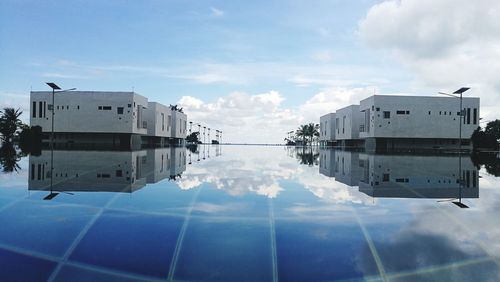 Reflection of building in lake against sky