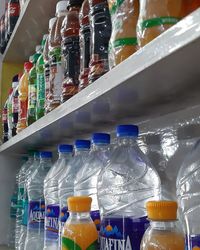 Close-up of bottles on shelf at market stall