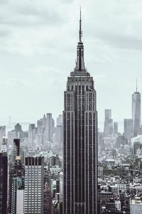 View of cityscape against cloudy sky