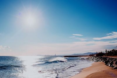 Scenic view of sea against bright sun