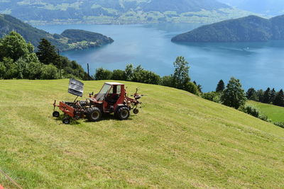Tractor on field against mountains