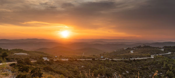 Scenic view of landscape against sky during sunset