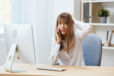 Young woman using laptop at home