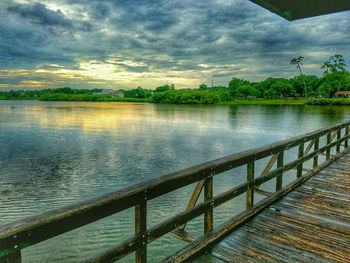 Scenic view of calm lake against cloudy sky