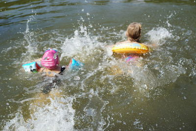 Rear view of girl enjoying in water