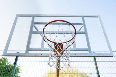 Action shot of basketball going through basketball hoop and net