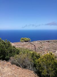 Scenic view of sea against clear blue sky