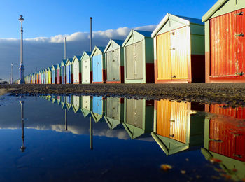 Multi colored umbrellas on beach by lake against sky