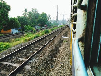 Railway tracks by train against sky