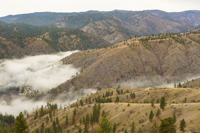 Mountain sunrise with clouds in the valley