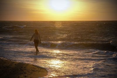 People on beach at sunset