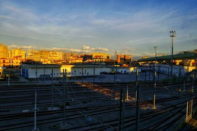 High angle view of railroad tracks by buildings against sky