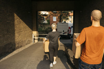 People carrying cardboard boxes