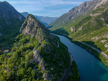 High angle view of river amidst mountains against sky