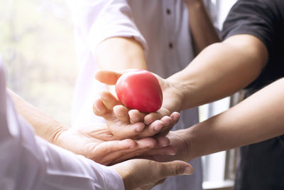 Midsection of couple holding hands