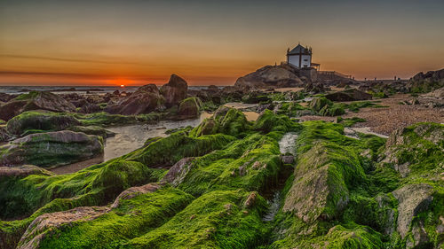 Panoramic view of lighthouse against sky during sunset