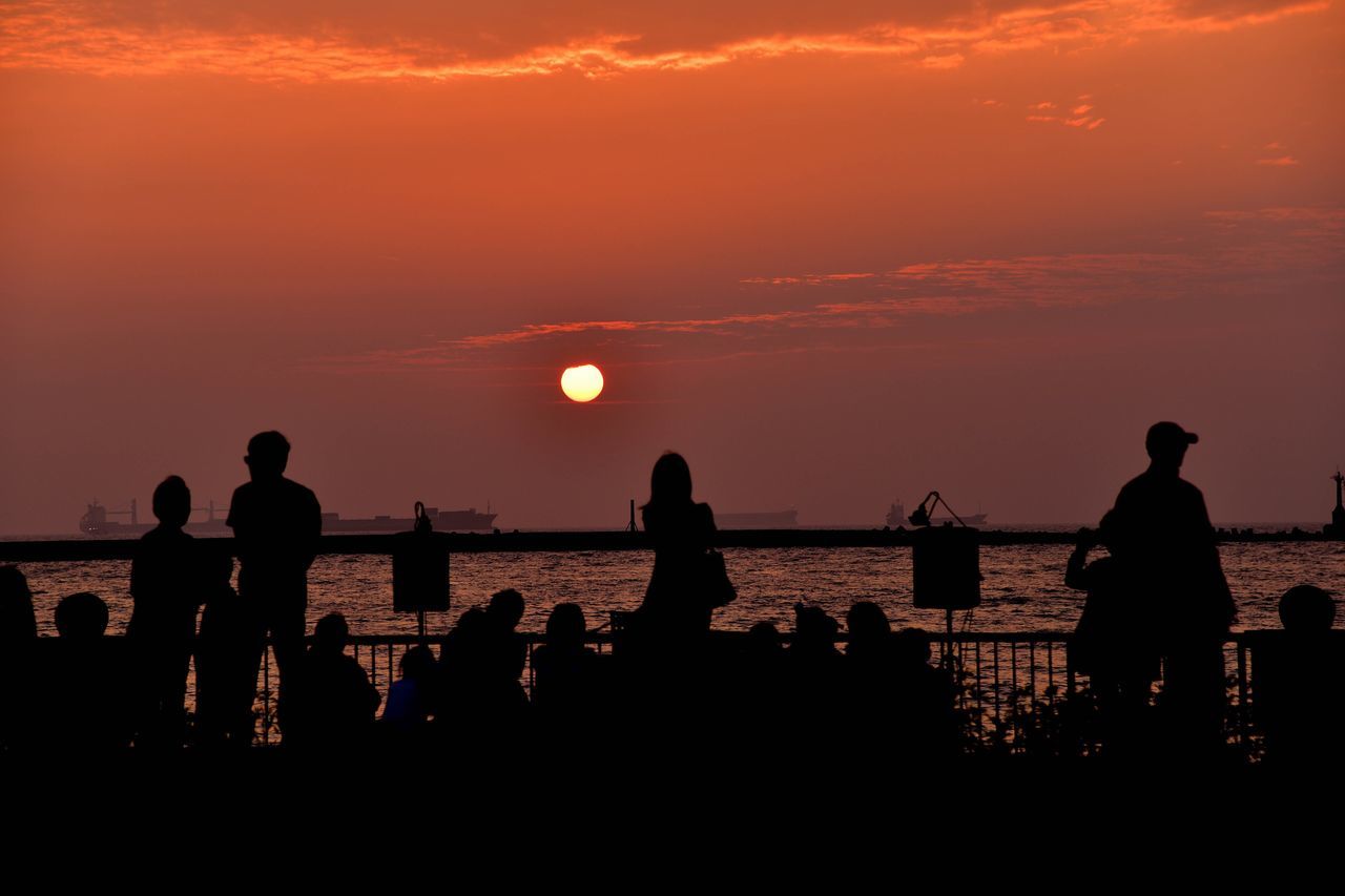 sunset, silhouette, water, sun, orange color, sea, sky, scenics, men, beauty in nature, leisure activity, tranquil scene, horizon over water, lifestyles, person, tranquility, idyllic, nature, togetherness