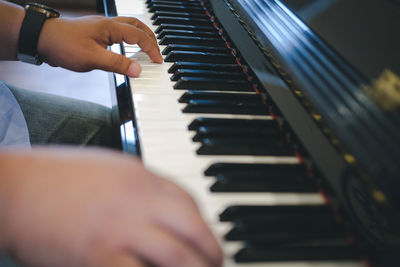 Close-up of man playing piano