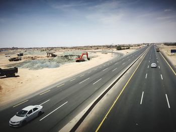 Vehicles on road against sky