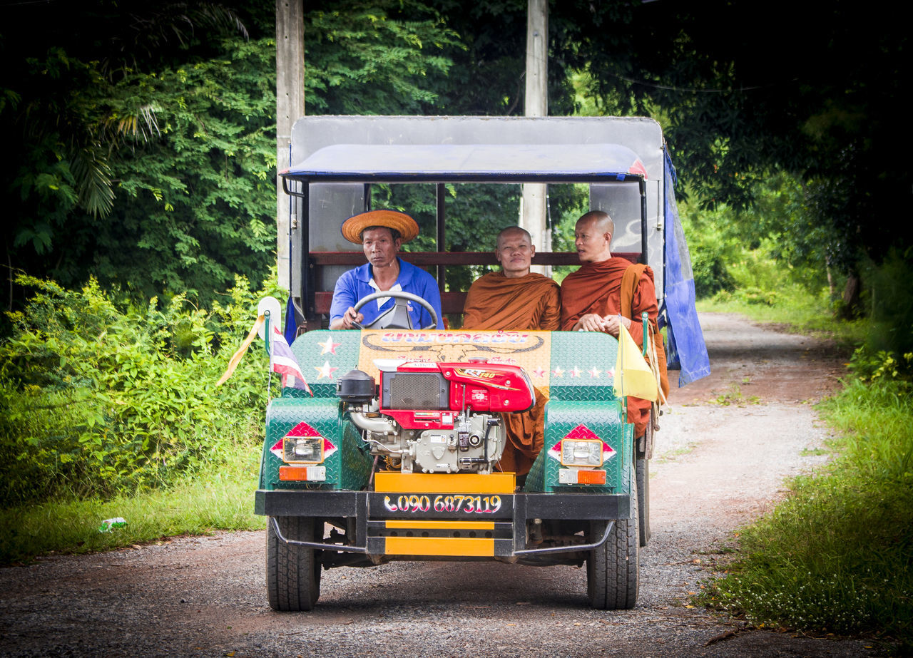 PORTRAIT OF PEOPLE SITTING ON ROAD