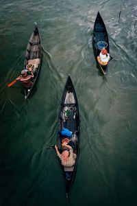 High angle view of men rowing boats in river