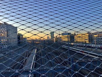 Cityscape seen through chainlink fence