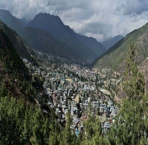 High angle view of townscape and mountains against sky