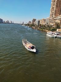 Scenic view of sea and buildings against clear sky