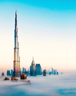 Tower amidst buildings against sky in city