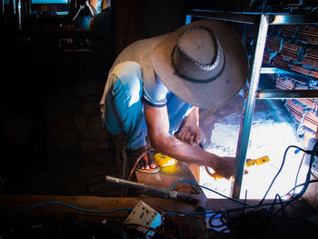 Khmer worker is welding in shirt and slippers