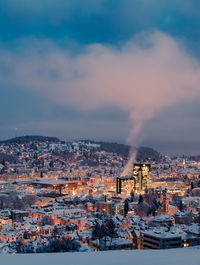 High angle view of illuminated city against sky during winter