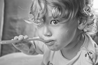 Close-up portrait of boy holding girl