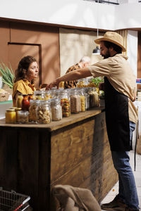 Side view of woman standing in cafe