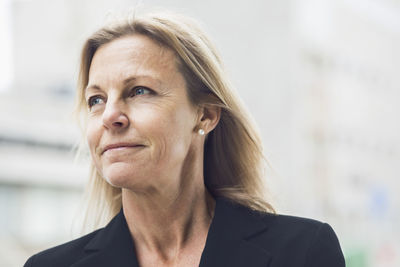 Thoughtful businesswoman looking away outdoors