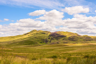 Scenic view of landscape against cloudy sky