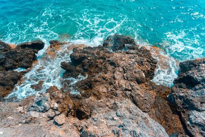 High angle view of rocks in sea