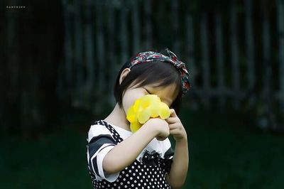 Close-up of woman holding flower