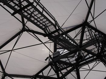 Low angle view of crane against sky