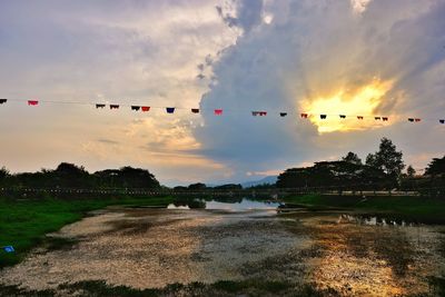 Scenic view of lake against sky during sunset