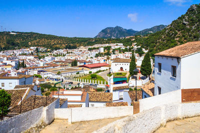 Houses in town against blue sky